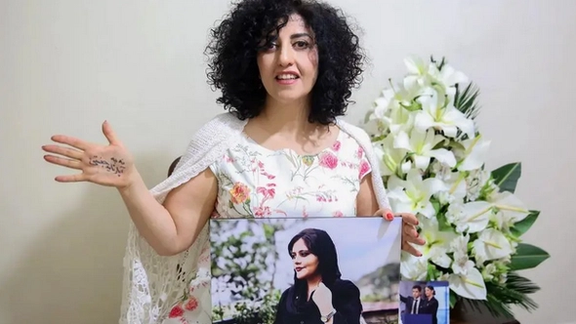 Narges Mohammadi with a picture of Mahsa Amini, Dec, 2024
