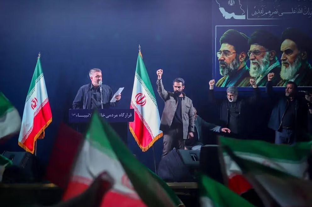 Men raise their fists during a pro-government gathering in Iran.