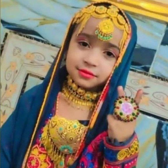 Eight-year-old Mona Naghib in traditional Baluchi dress