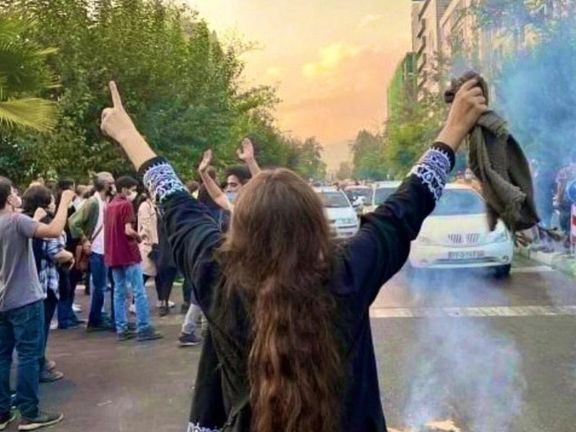 A woman who took off her headscarf protesting in the streets