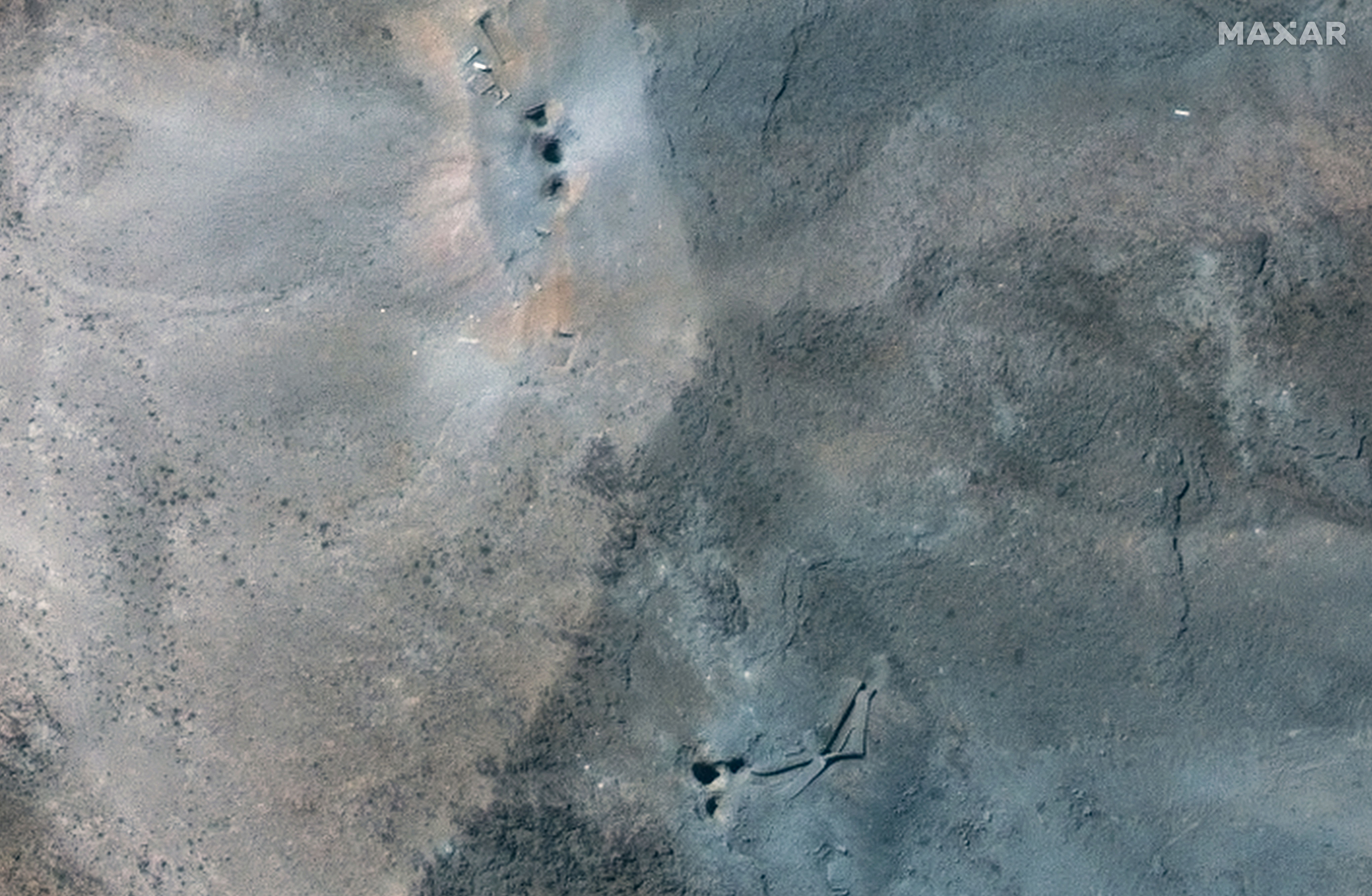 A closer satellite view shows holes and craters on a ridge at Fordow underground complex, after the US struck the underground nuclear facility, near Qom, Iran June 22, 2025. 
