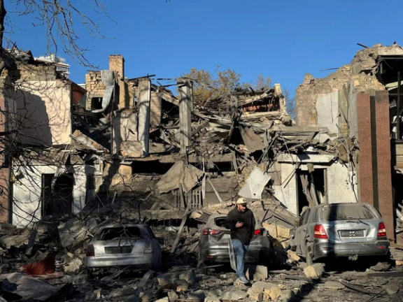 A resident walks next to buildings and cars heavily damaged by a Russian missile strike, amid Russia's attack on Ukraine, in Odesa, Ukraine November 25, 2024.