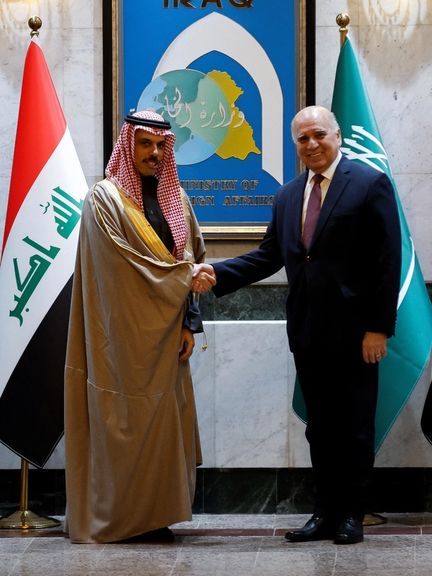 Saudi Arabia's Foreign Minister Prince Faisal bin Farhan Al Saud and Iraqi Foreign Minister Fuad Hussein shake hands, at the Ministry of Foreign Affairs in Baghdad, Iraq February 2, 2023.
