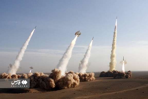 File photo of several Iranian missiles being fired during war games