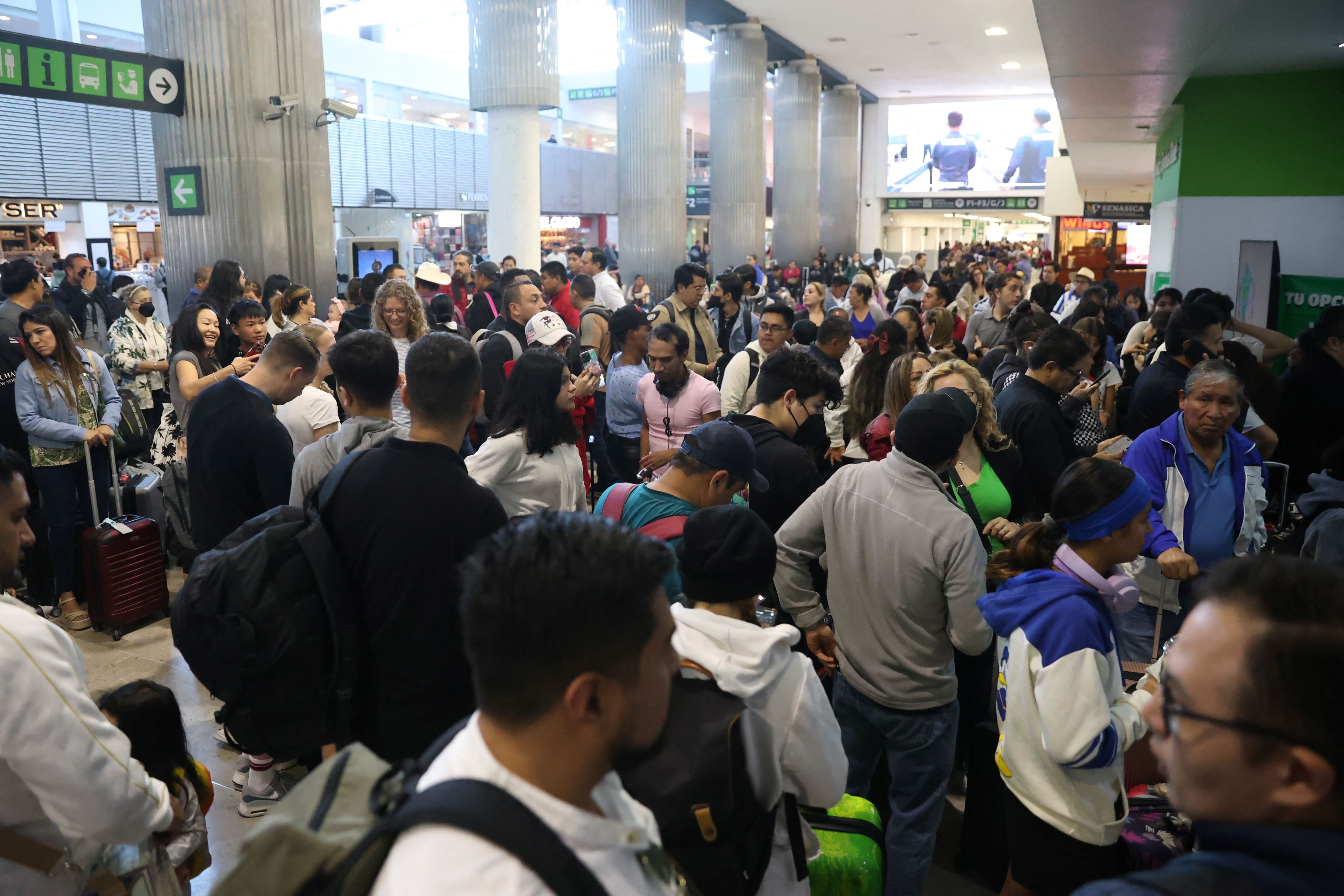 Passengers wait at the Benito Juarez International Airport due to a worldwide tech outage that caused flight delays, in Mexico City, Mexico July 19, 2024. REUTERS/Luis Cortes