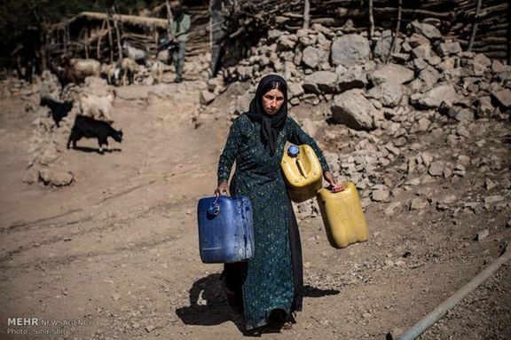 An Iranian woman carrying water tanks in rural areas