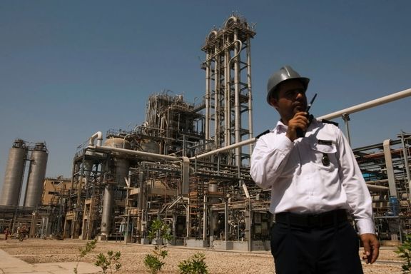 A security person stands in front of the Mahshahr petrochemical plant in Khuzestan province, September 28, 2011.