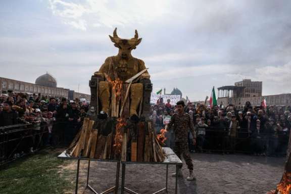 Demonstrators burn a large horned, bull-headed “Baal” statue during a state-organized rally marking the anniversary of Iran’s 1979 Islamic Revolution in Isfahan on February 11, 2026.