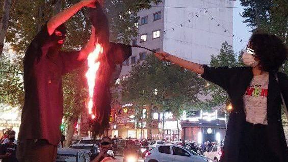 A woman burning her hijab headscarf in Lahijan, a provincial town, September 2022