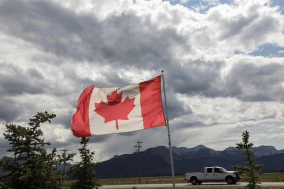 A Canadian flag flies near the mountains ahead of the G7 summit near Kananaskis, Alberta, Canada June 14, 2025.