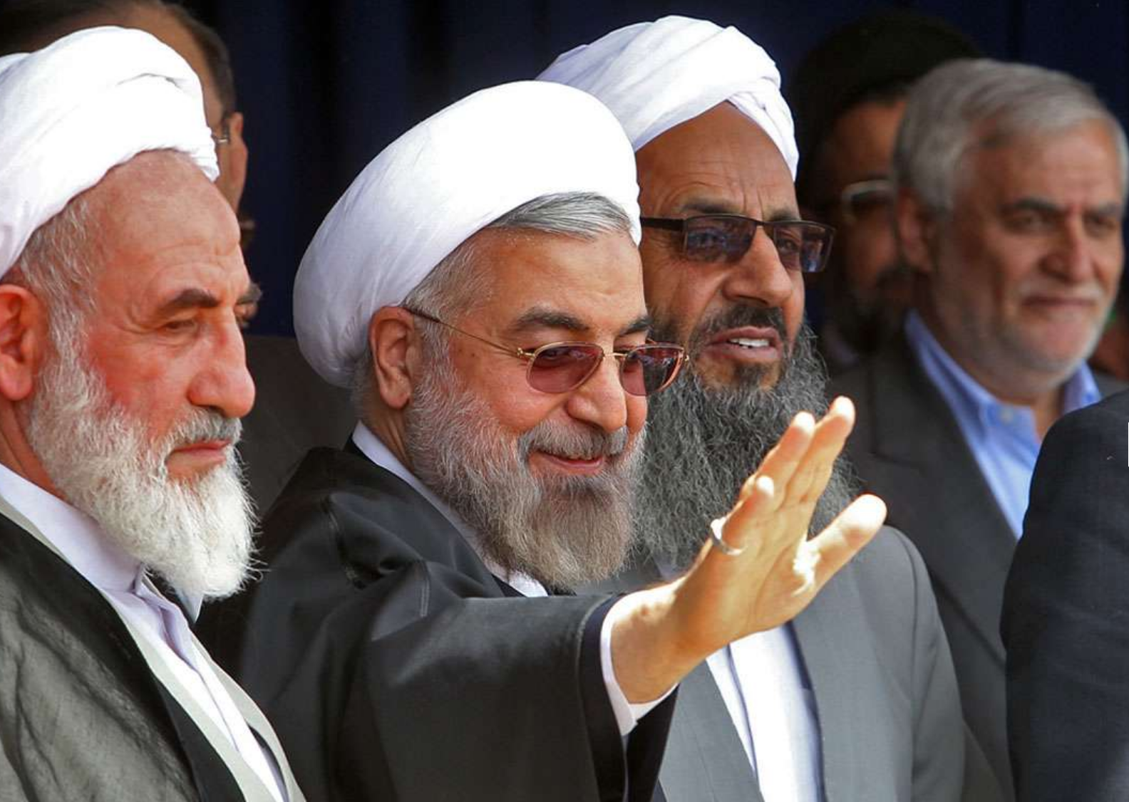Former president Hassan Rouhani standing next to Mowlavi Abdolhamid