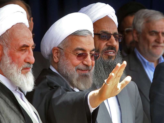Former president Hassan Rouhani standing next to Mowlavi Abdolhamid (undated)