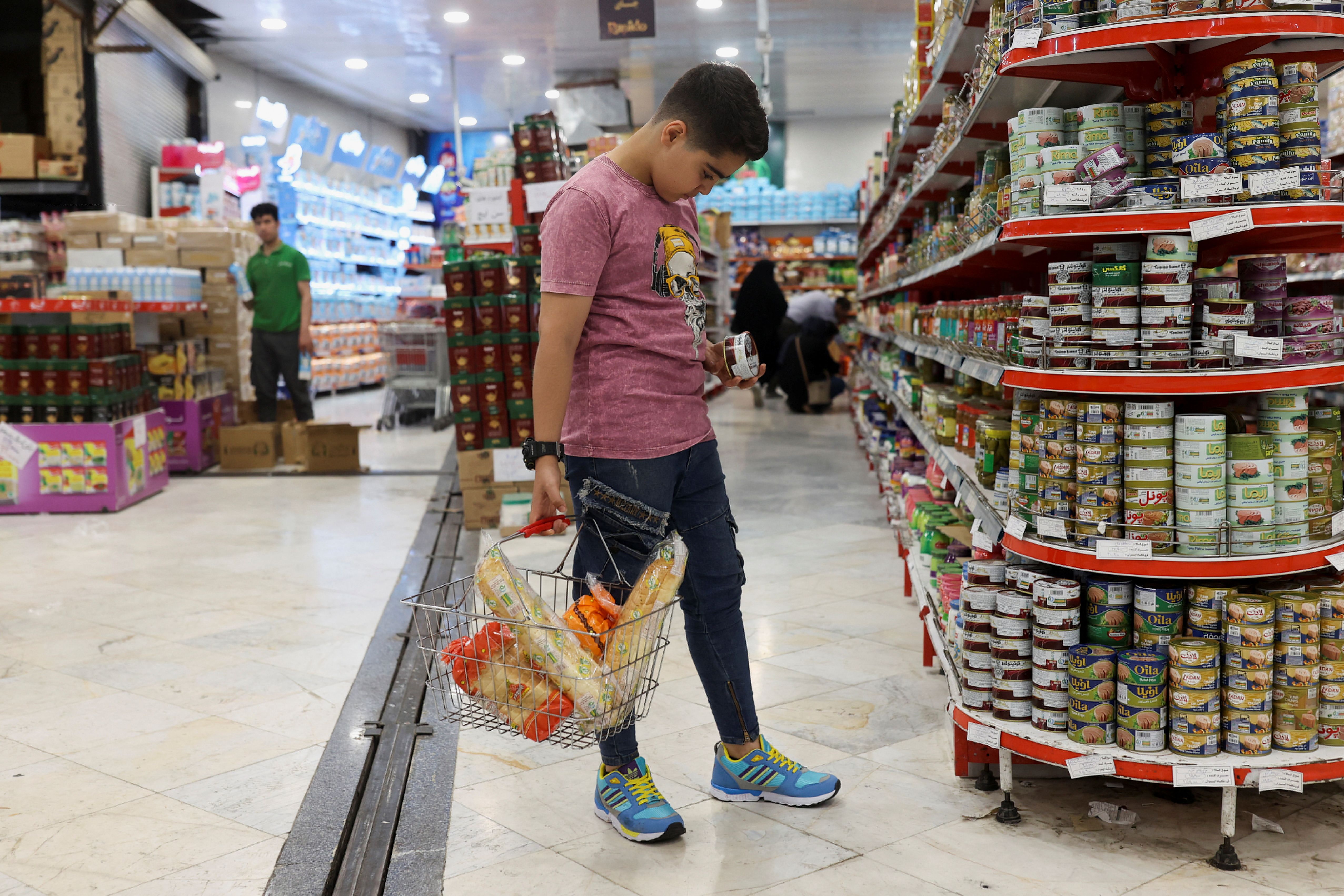A shopper in Tehran looking at prices that climb higher.