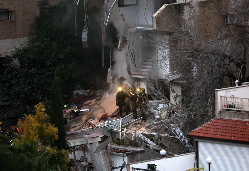 First responders work at the site of a projectile impact, as the US.Israel conflict with Iran continues, in northern Israel, April 5, 2026. 