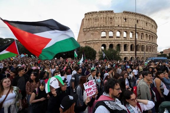 People hold Palestinian flags in front of the Colosseum during a demonstration amid the conflict between Israel and the Palestinian Islamist group Hamas, in Rome, Italy, October 28.