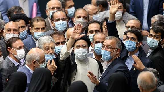 President Ebrahim Raisi surrounded by conservative supporters after his inauguration in parliament in August.