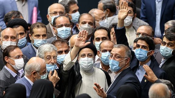 President Raisi among a happy crowd of conservatives in parliament during his inauguration in August.