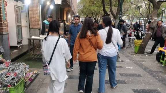 Women in Tehran walking in public without headscarves. 2023
