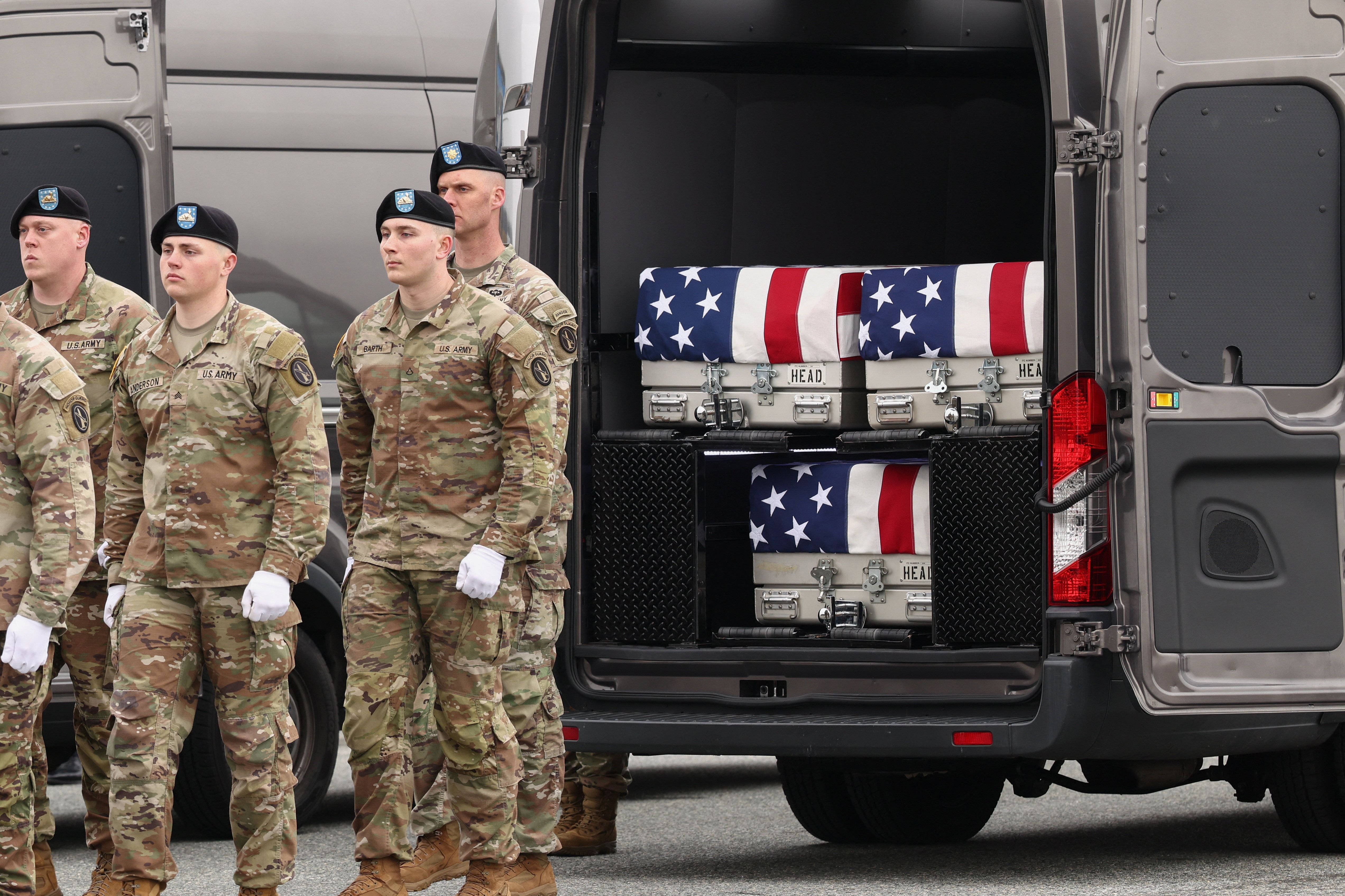 Members of the military stand as transfer cases lie inside a vehicle during a dignified transfer of the remains of six U.S. Army service members of the 103rd Sustainment Command, who were killed in Kuwait, Major Jeffrey O'Brien, Capitain Cody Khork, Chief Warrant Officer 3 Robert Marzan, Sergeant 1st Class Nicole Amor, Sergeant 1st Class Noah Tietjens and Sergeant Declan Coady, amid the U.S.-Israeli conflict with Iran, at Dover Air Force Base in Dover, Delaware, U.S., March 7, 2026.