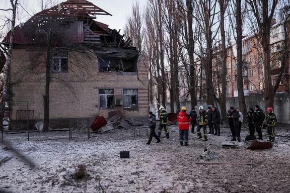 Rescuers and police officers examine parts of the drone at the site of a building destroyed by a Russian drone attack, as their attack on Ukraine continues, in Kyiv, December 14, 2022