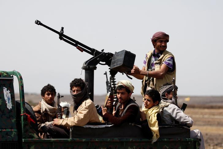 Houthi fighters ride on the back of a patrol truck as they secure the site of a pro-Houthi tribal gathering in a rural area near Sanaa, Yemen July 21, 2016.