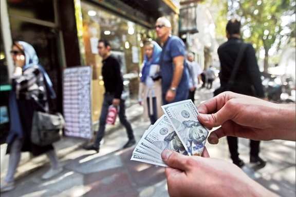 Undated phot shows street dealer offering US dollars in Tehran
