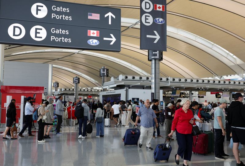 Passengers carry their luggage at Toronto Pearson International Airport, following the end of the Air Canada labour strike, in Mississauga, Ontario, Canada, August 19, 2025.
