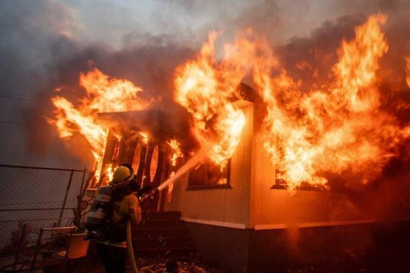 A firefighter battles the Palisades Fire as it burns during a windstorm on the west side of Los Angeles, California, US January 7, 2025.