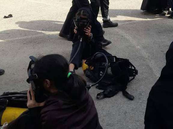 Schoolgirls breathing through oxygen masks after a chemical gas attack on their school