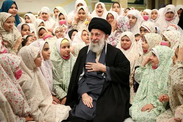 Iran’s Supreme Leader Ali Khamenei among a group of schoolgirls (Undated)