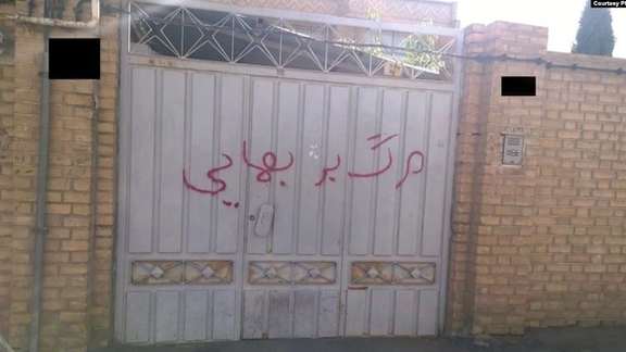 "Death to Baha'is" written on the gate of a house belonging to a Baha'i family