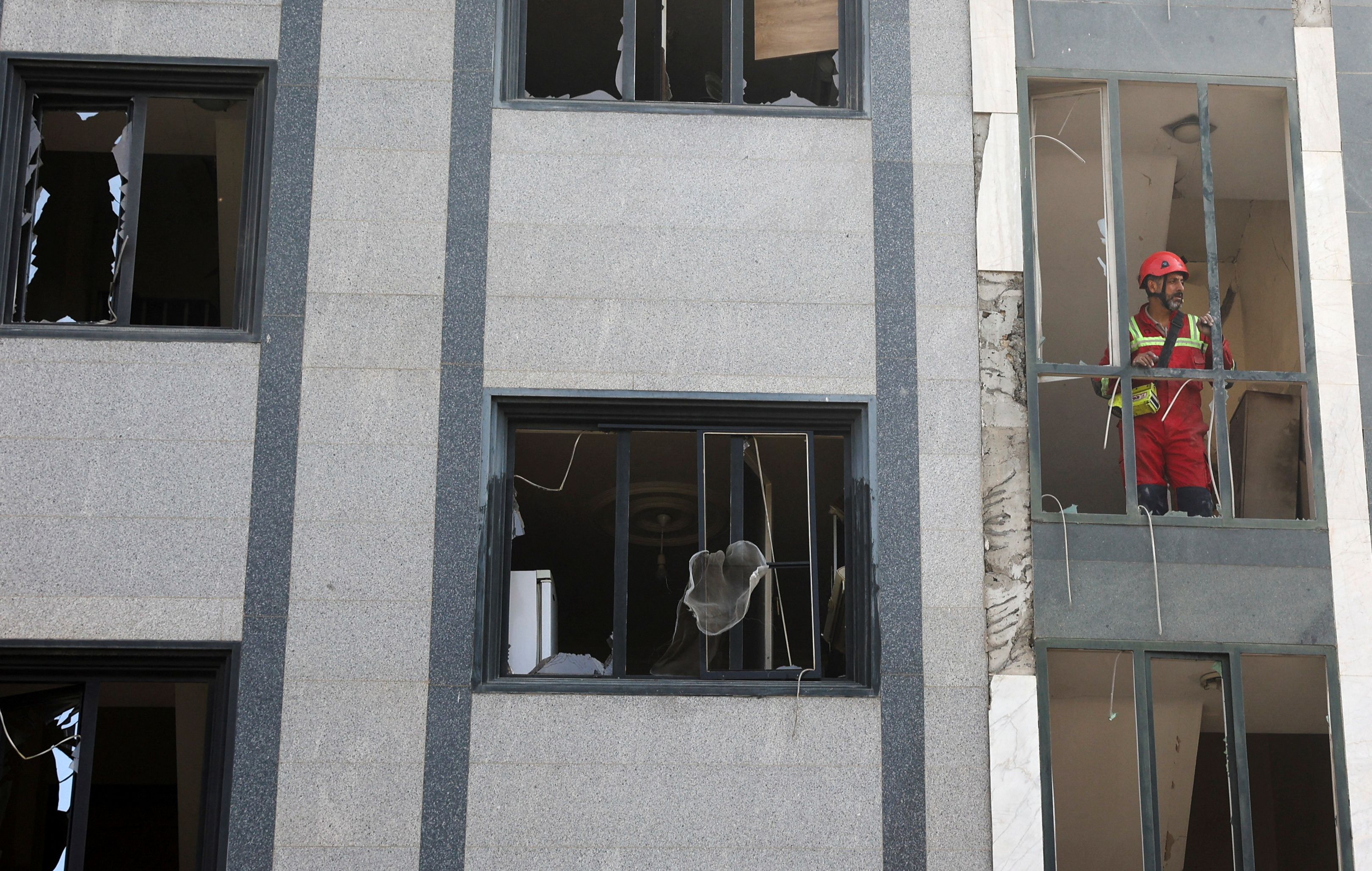 A rescuer looks out from a damaged building in the aftermath of Israeli strikes, in Tehran, Iran, June 13, 2025. 