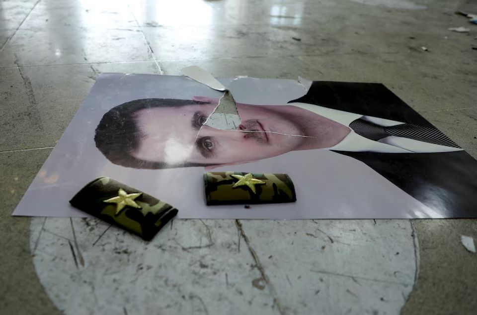 A damaged picture of Syria's Bashar al-Assad lies on the floor inside Qamishli international airport, after Syrian rebels announced that they have ousted Syria's Bashar al-Assad, in Qamishli, Syria December 9, 2024.