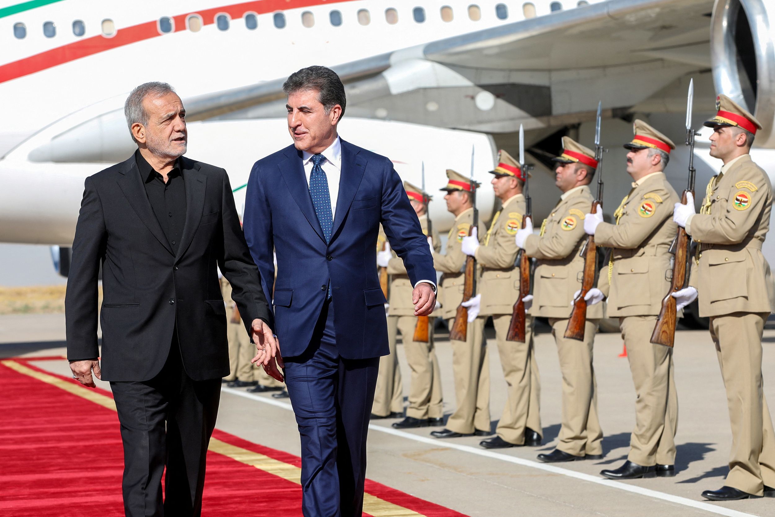 President of Kurdistan Region in Iraq, Nechirvan Barzani welcomes Iran's President Masoud Pezeshkian at Erbil International Airport, in Erbil, Iraq, September 12, 2024.