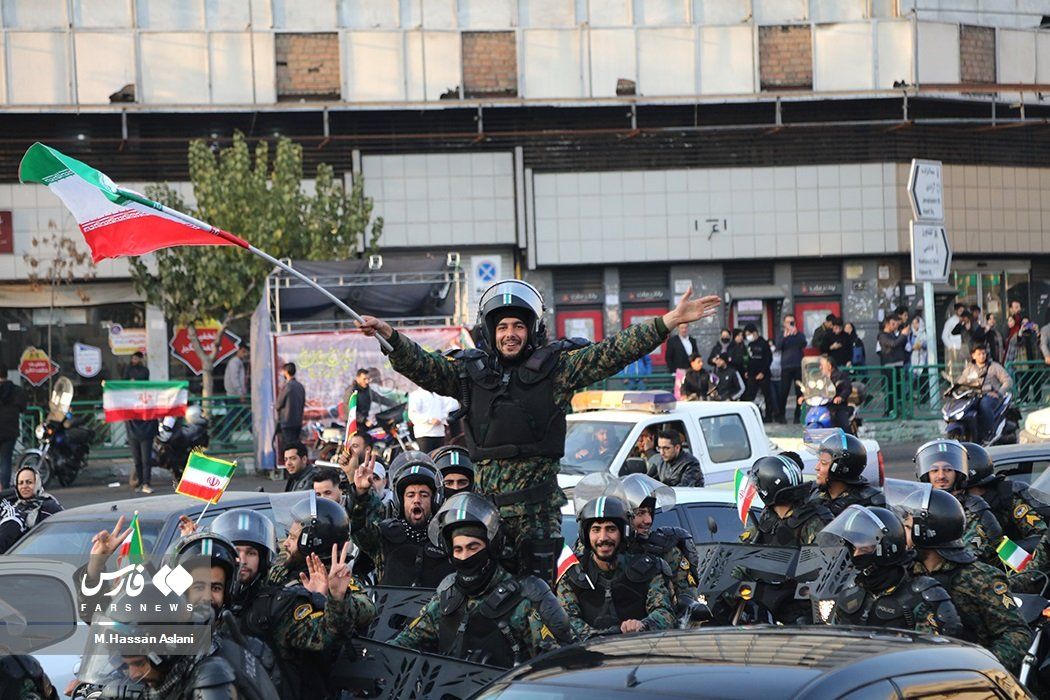Forces of the Islamic Republic’s riot police celebrating on streets after Iran’s 2-0 victory against Wales on November 25, 2022  