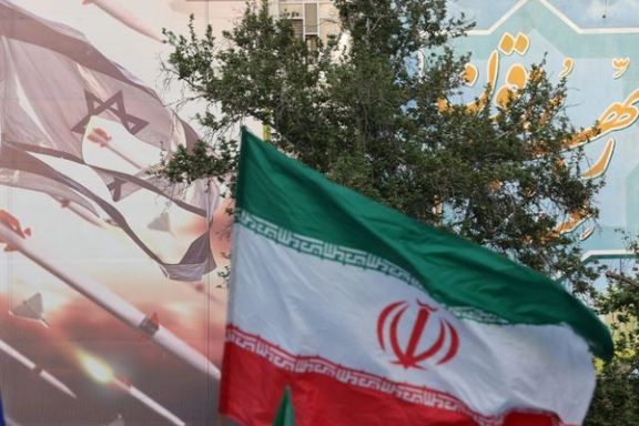 FILE PHOTO: An anti-Israel billboard is seen next to the Iranian flag during a celebration following the IRGC attack on Israel, in Tehran, Iran, April 15, 2024.