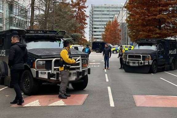 Armored police vehicles are seen outside the headquarters of Iran International on Nov. 19, 2022