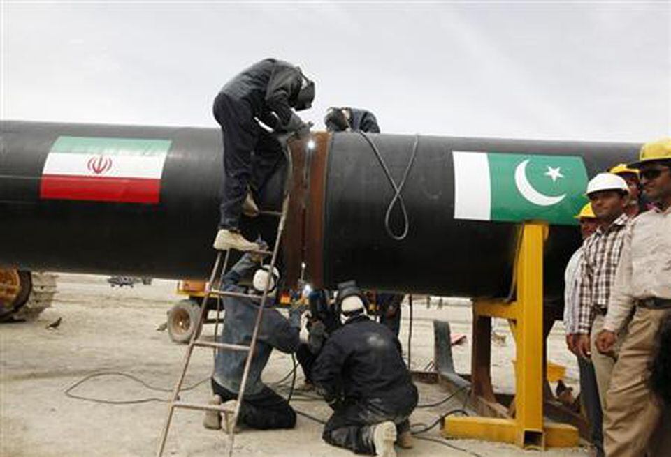 Iranian workers welding the pipeline during a groundbreaking ceremony to mark the inauguration of the Iran-Pakistan gas pipeline, in the city of Chabahar in southeastern Iran March 11, 2013 