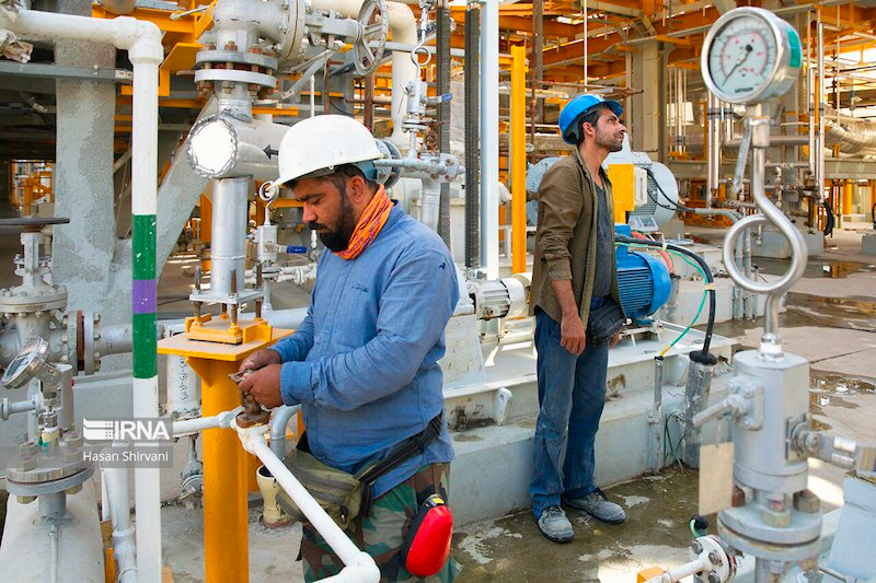 Workers at an oil plant in southern Iran  