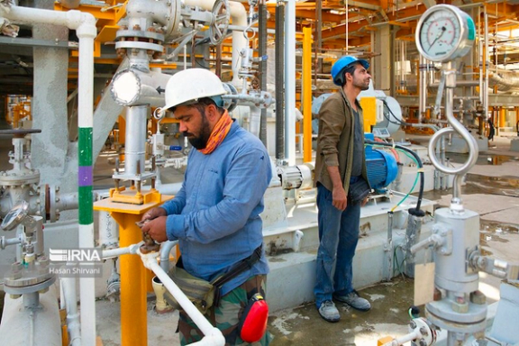 Workers at an oil plant in southern Iran