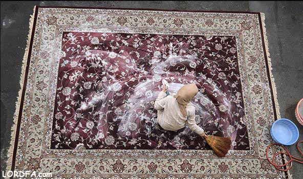An Iranian person washes a carpet during traditional spring cleaning, known as khaneh-Tekani, ahead of the Nowruz new year celebrations.