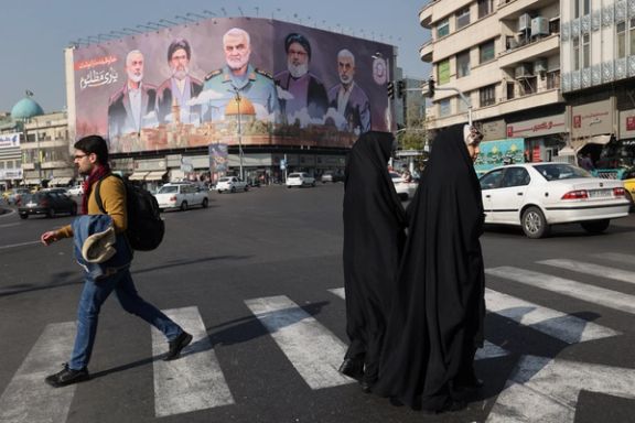Iranians walk next to a billboard with a picture of late Hamas leader Ismail Haniyeh, late senior Iranian military commander General Qassem Soleimani, late Lebanon's Hezbollah leader Sayyed Hassan Nasrallah and late Hamas leader Yahya Al-Sinwar on a street in Tehran, Iran, January 16, 2025.
