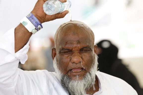 A Muslim pilgrim pours water on his head to cool down from the heat, as he takes part in the annual haj pilgrimage in Mina, Saudi Arabia, June 17, 2024.