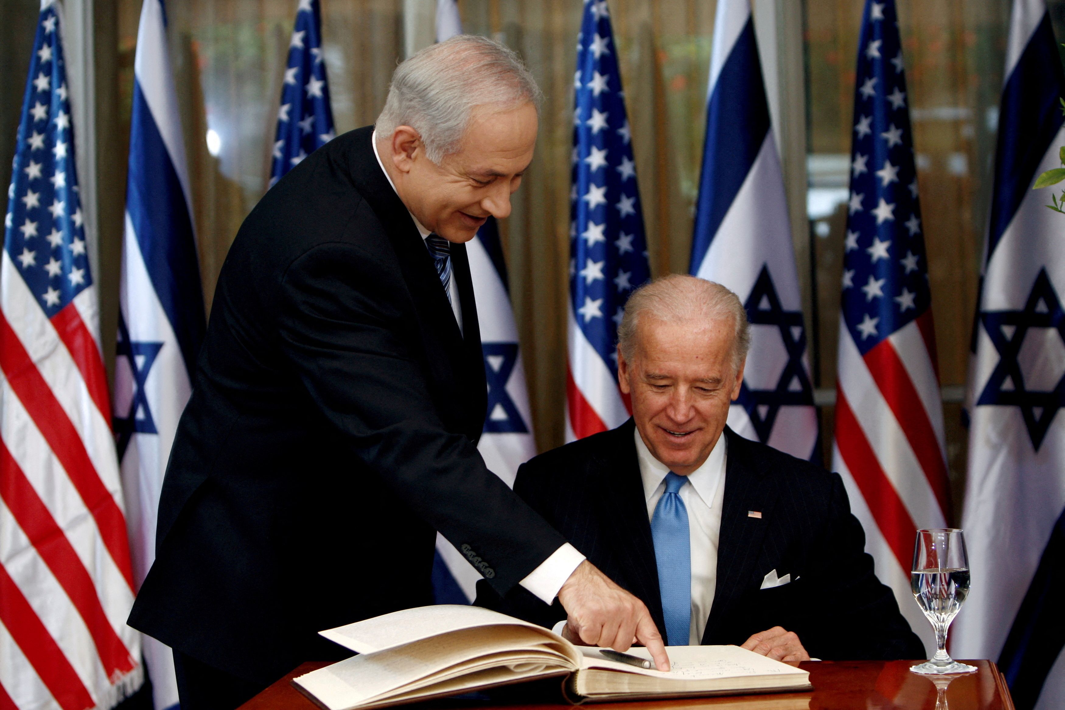 Then-Vice President Joe Biden (right) prepares to sign the guest book before his meeting with Israel's Prime Minister Benjamin Netanyahu at Netanyahu's residence in Jerusalem on March 9, 2010. 