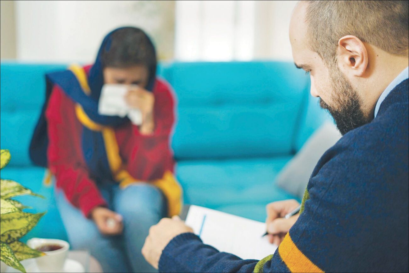 A therapist meets with a patient in Iran, where rising treatment costs are making mental healthcare less affordable. (undated)