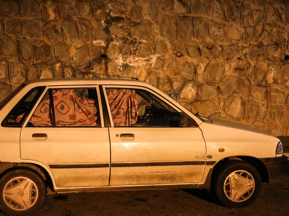 A photo of a car parked in northern Tehran, its driver asleep inside. (Undated)