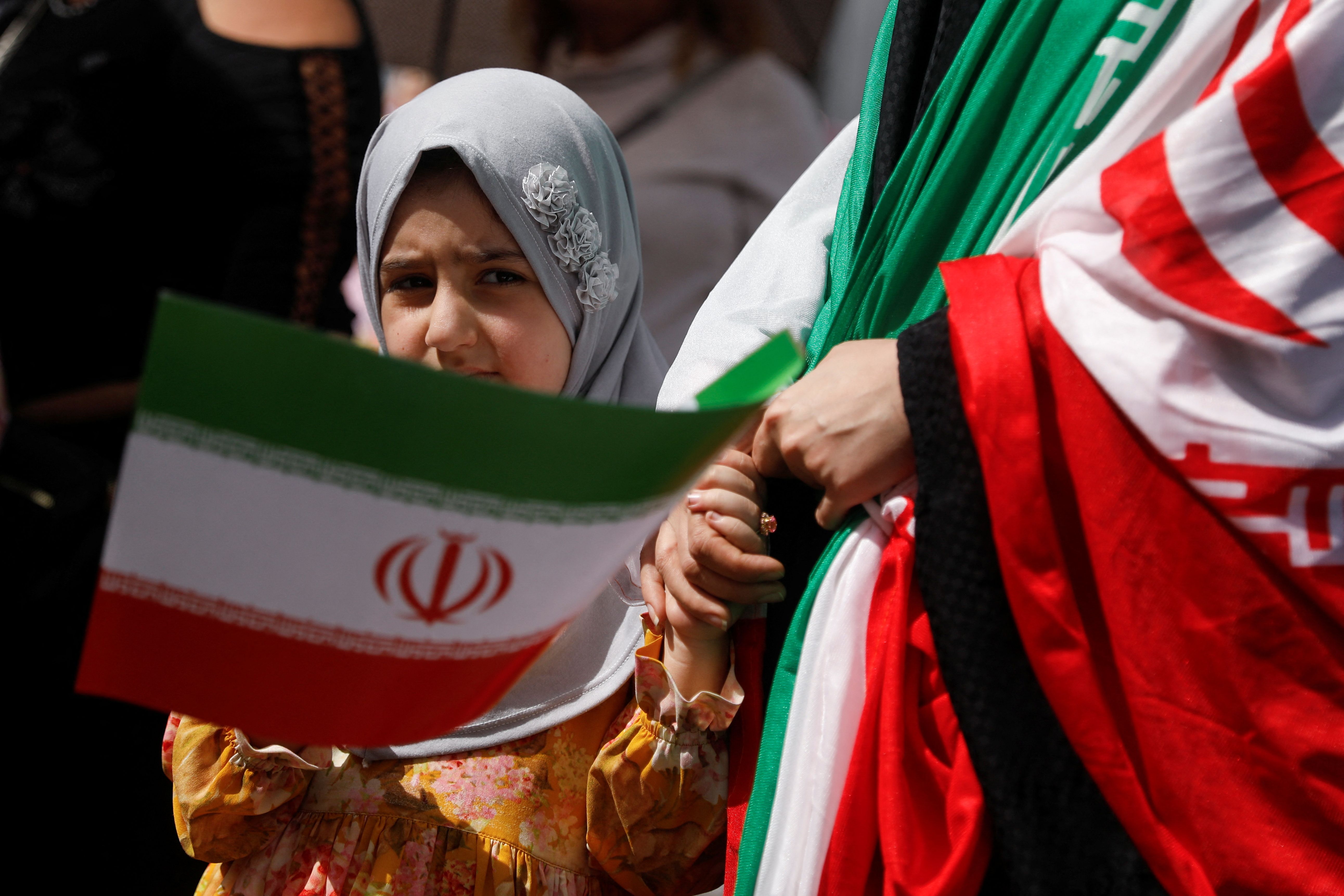 A child holds the flag of Iran while participating in a march in support of Iran amid the ongoing conflict between Israel and Iran, in Caracas, Venezuela June 19, 2025.
