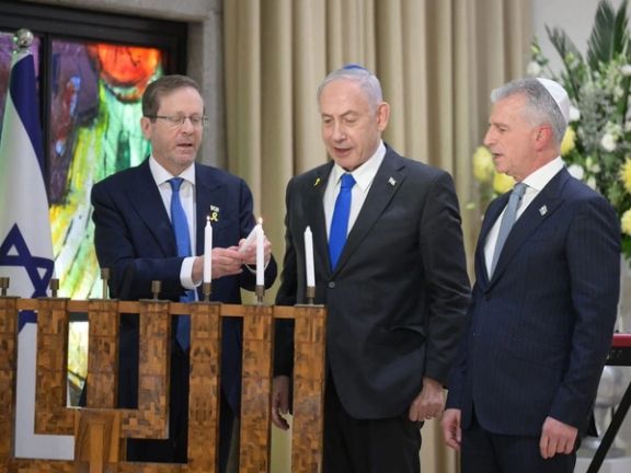 Head of the Mossad intelligence agency David Barnea, right, attends a Hanukkah event in Jerusalem alongside Prime Minister Benjamin Netanyahu and President Isaac Herzog on December 16, 2025.