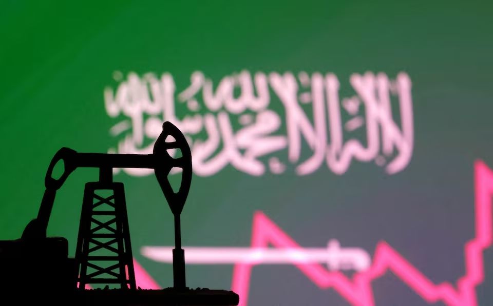 Saudi Arabian flag with stock graph and an oil pump jack miniature model are seen in this illustration taken October 9, 2023.
