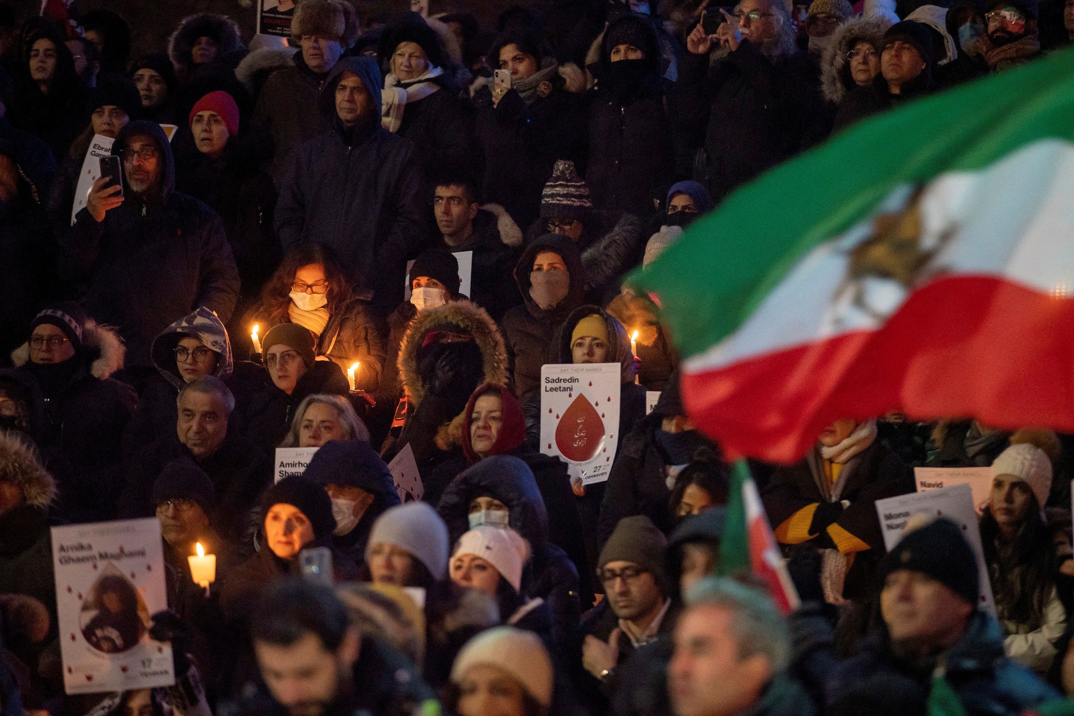 People hold candles at an event marking the third anniversary of the downing of Ukraine International Airlines flight PS752, which was shot down near Tehran by Iran's Revolutionary Guards, in Toronto, Ontario, Canada January 8, 2023. 